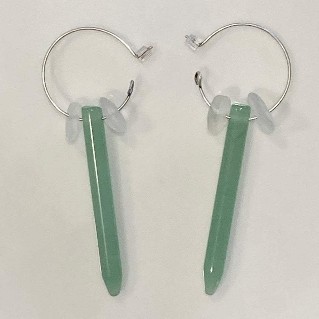 Pair of hoop earrings with green bar pendants on a white background